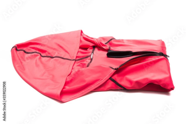 Fototapeta Folded red zipper windbreaker jacket, UV sun proof outdoor jacket hoodie. Track jacket sport hoodie full zip isolated on white background. Folded clothes.