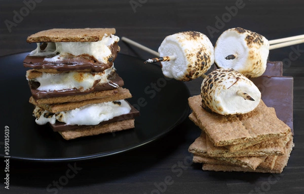 Obraz Smores roasted with crackers, marshmallows and chocolate to the side.