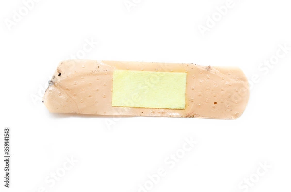 Fototapeta Used antibacterial patch on a white background in macro. Dirty patch, orange yellow top and side view