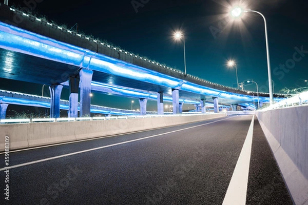 Obraz Empty road floor with city viaduct bridge of neon lights night