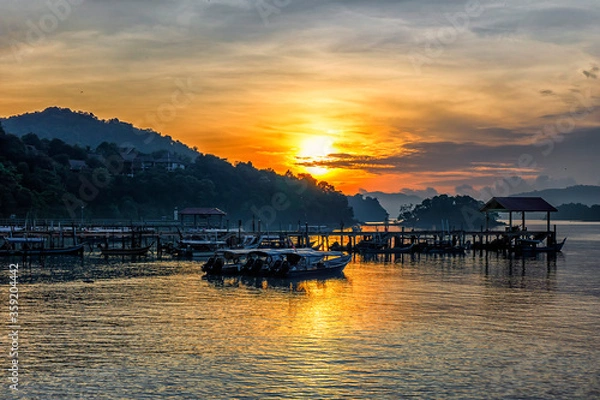 Fototapeta Beautiful landscape view of a jetty in Tengah beach during sunrise in Langkawi.Soft focus effect due to large aperture setting.