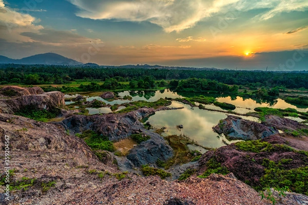 Fototapeta Beautiful high angle view of a used quary during sunset.