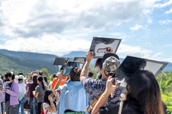 Obraz Chiang Mai, Thailand - June 21, 2020 : Partial solar eclipse, People viewing a solar eclipse via DIY telescope with indirect observation method at Princess Sirindhorn AstroPark.