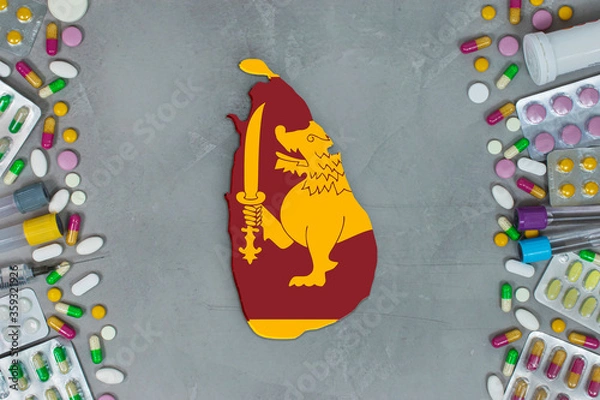 Obraz The Sri Lanka State began research for treatment and medicine to combat the pandemic outbreak disease coronavirus. Medicine, pills, needles, syringes and Sri Lanka map and flag on gray background.
