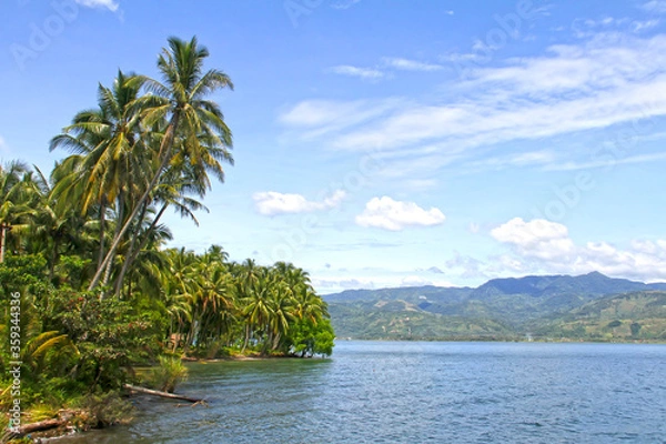 Fototapeta Lake Singkarak as seen from the eastern side of the lake with a railway track in West Sumatra, Indonesia.