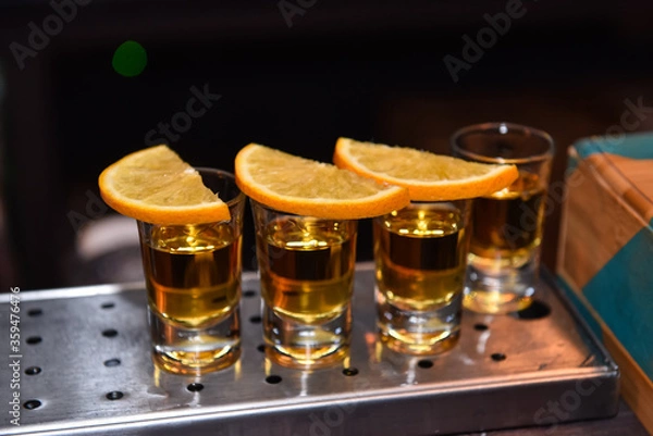 Fototapeta Various alcoholic shots in shot glasses in a serving tray often used for offers in the drinks industry