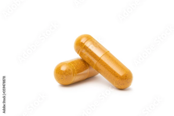 Fototapeta  dry Turmeric powder in capsule  isolated on white background.