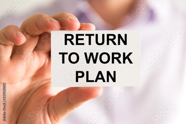 Obraz Businessman holding Returning To Work Plan message card
