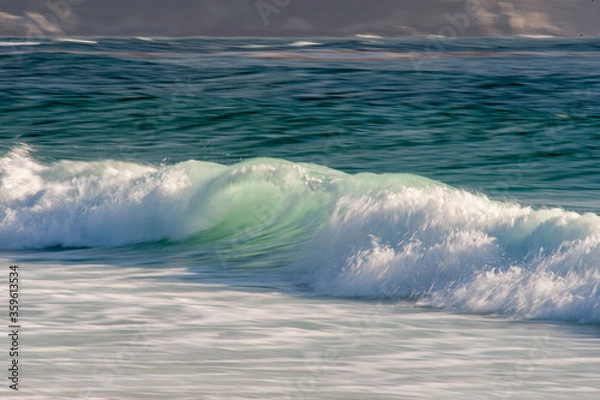 Obraz Breaking wave rolling into the sandy beach in Central California