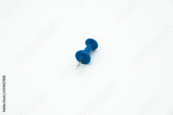 Obraz isolated blue pushpin in a white background