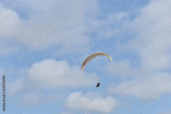 Fototapeta Paragliding at the beach of Katwijk aan Zee. Paraglider's making use of updraft of the dunes to stay in the air 
