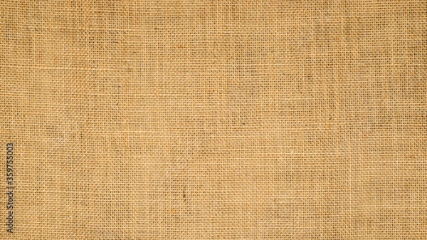 Fototapeta Cotton woven fabric background with flecks of varying colors of beige and brown. with copy space. office desk concept / Hessian sackcloth burlap woven texture background High Resolution horizontal .