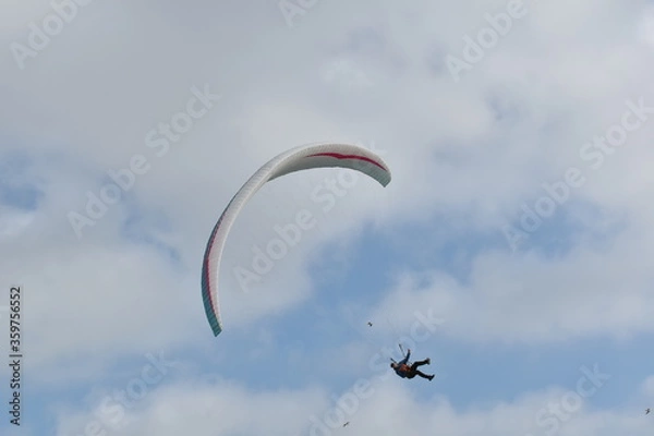 Fototapeta Paragliding at the beach of Katwijk aan Zee. Paraglider's making use of updraft of the dunes to stay in the air