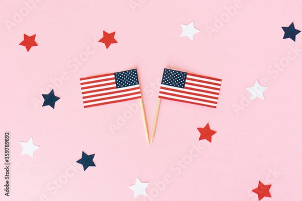 Obraz Two american flag toothpick and star on pink background, flat lay. 4th of july, usa independence day. Celebration in America.