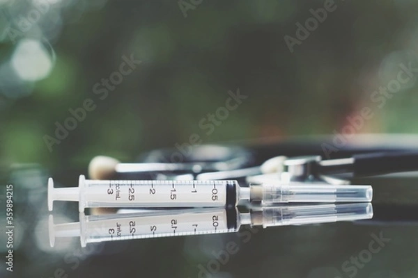 Obraz syringe and stethoscope on table