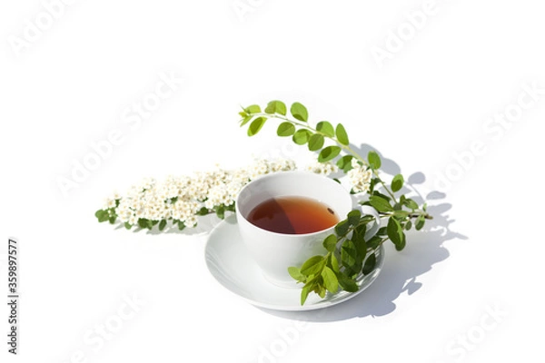 Fototapeta White tea mug with flowers on white background