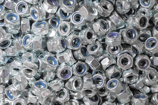 Fototapeta Nuts. Texture. A lot of rubberized nuts for bolts and screws. Background for wallpaper. Female screw. Screw-nut. Internal screw.