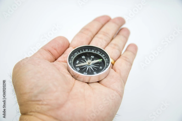 Obraz The compass on my hand is in a white background.