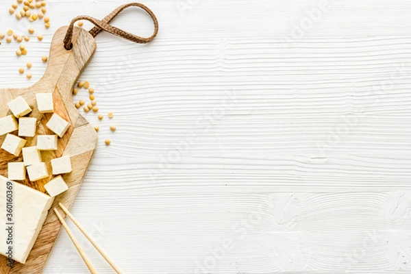 Fototapeta tofu vegan food on cutting board on white table top view copy space