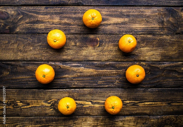 Obraz many oranges on wooden background
