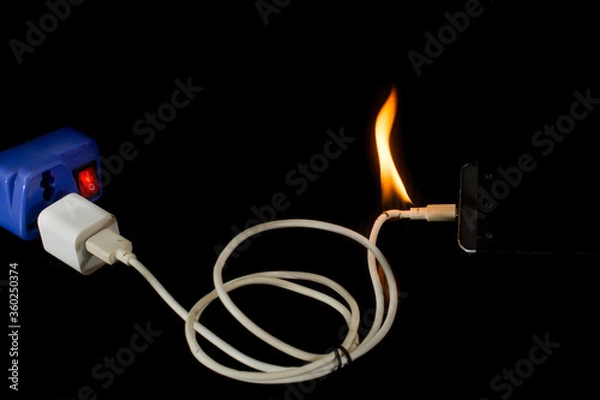 Fototapeta mobile phone battery explode with catch fire in line charger