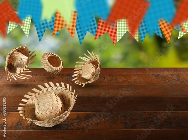 Obraz Group of hats from the Festa Junina, a typical Brazilian party on a green and wood background. Selective focus