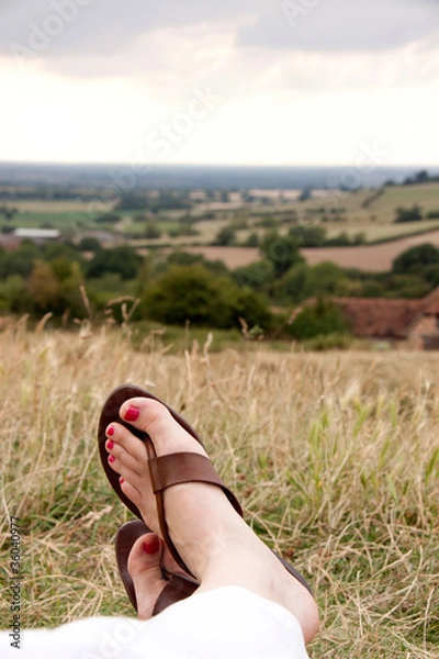 Obraz feet crossed relaxing in flip flops