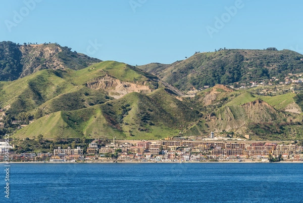 Fototapeta The Strait of Messina is a narrow strait between the eastern tip of Sicily and the western tip of Calabria in the south of Italy. It connects the Tyrrhenian Sea to with the Ionian Sea.