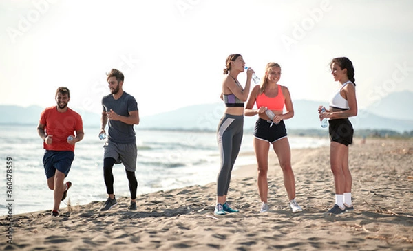 Obraz Active people on the beach running and exercise.Healthy lifestyle on vacation.