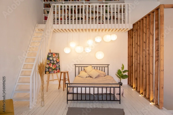 Fototapeta luxury modern design of a cozy small Scandinavian-style studio apartment with white walls, second floor with a library and huge high window full of day light
