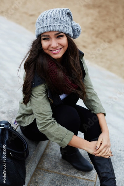 Fototapeta Portrait of laughing woman sitting on the steps at leisure time outdoors