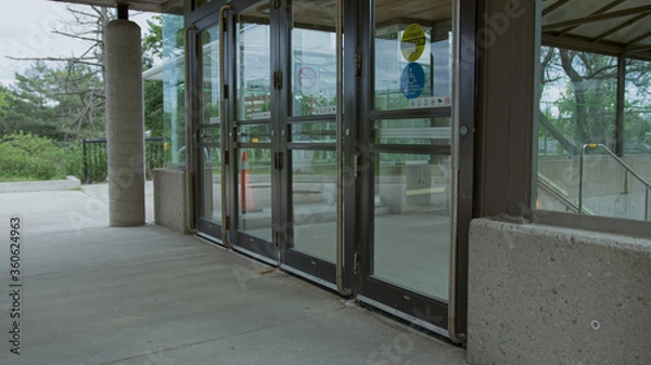 Fototapeta High quality picture of a closed glass doors on the subway or train station. GO transit in Canada.