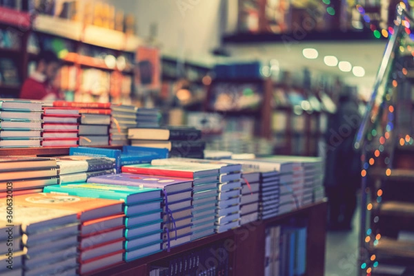 Fototapeta lot of new books in hardcover. image of Abstract Blur people at book store in shopping mall for background usage. toned