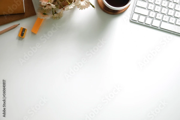 Fototapeta Top view office stuff with notepad, laptop and coffee cup mouse notepad shot.blank screen mobile phone and supplies on white desk workspace and copy space.