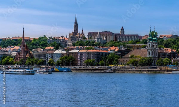 Fototapeta The Castle District and waterfront viewed from the east bank of the River Danube in Budapest during summertime