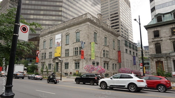Fototapeta Montreal, QC/Canada - 6/26/2020: a combination of old and modern architecture at the same scene, the historical building of McCord museum with a background of a modern building of McGill univeristy.