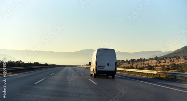 Obraz commercial van is delivering cargo to countryside