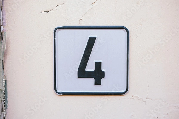 Obraz number four on a wall