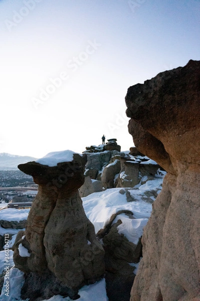 Fototapeta man on distant rocks