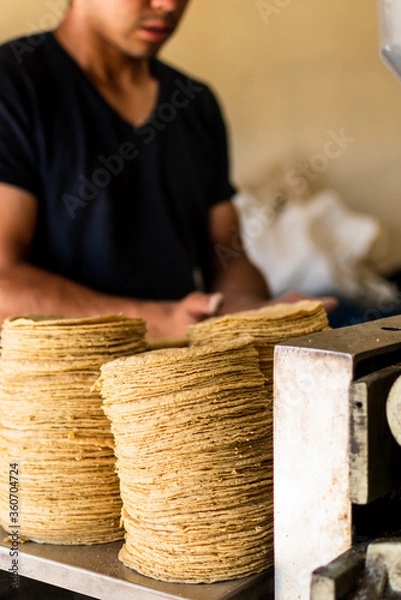 Obraz tortillas stacked on a tortilla machine