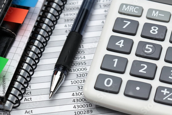 Fototapeta business office desk closeup - financial reports, analysis and accounting, set of documents, tables and graphs, various items for bookkeeping, calculator