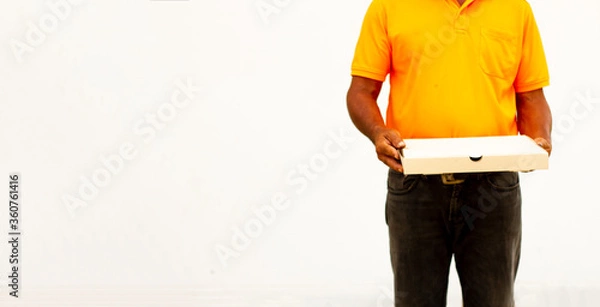 Obraz Holding various take-out food containers in holder and paper bag, close-up. Light grey background, place to insert your text. Delivery man.