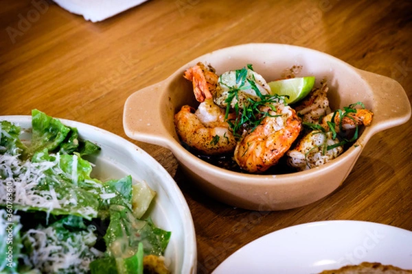 Obraz Grilled Gambas al Ajillo, Spanish chilli-and-garlic shrimp, served on a wooden table