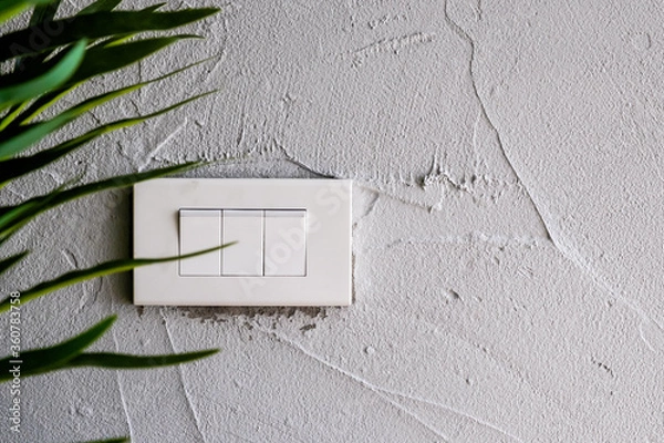 Obraz Isolated white light switch on grunge wall background