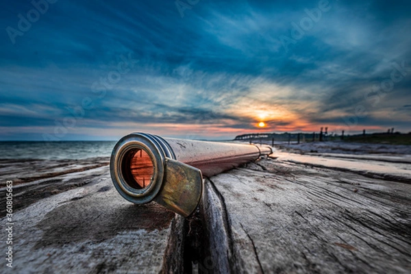 Obraz old binoculars on the beach