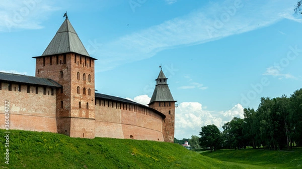 Fototapeta high brick wall of the fortress with towers
