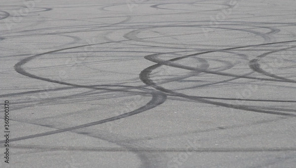Obraz Background asphalt road with car tire skid mark on the track, abstract car drift tire skid mark texture.