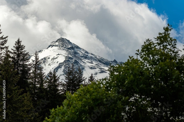 Obraz Clouds over the snowy mountain