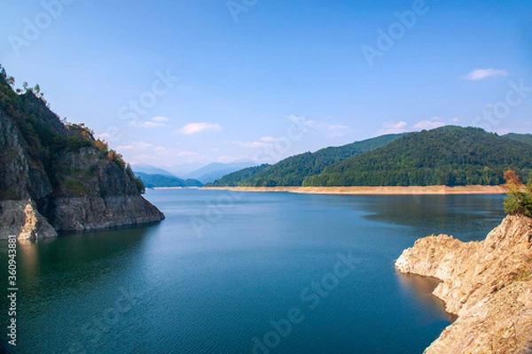 Fototapeta A beautiful landscape with the Vidra lake. Transfagarasan Road. The calm water of the storage lake Vidra.