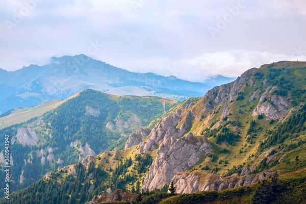 Fototapeta A beautiful mountain landscape with rocks, fir trees, mountain peaks